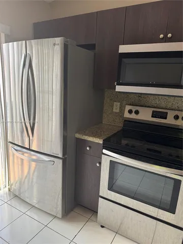 a stove top oven sitting inside of a kitchen
