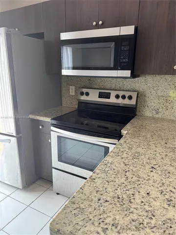 a stove top oven sitting inside of a kitchen