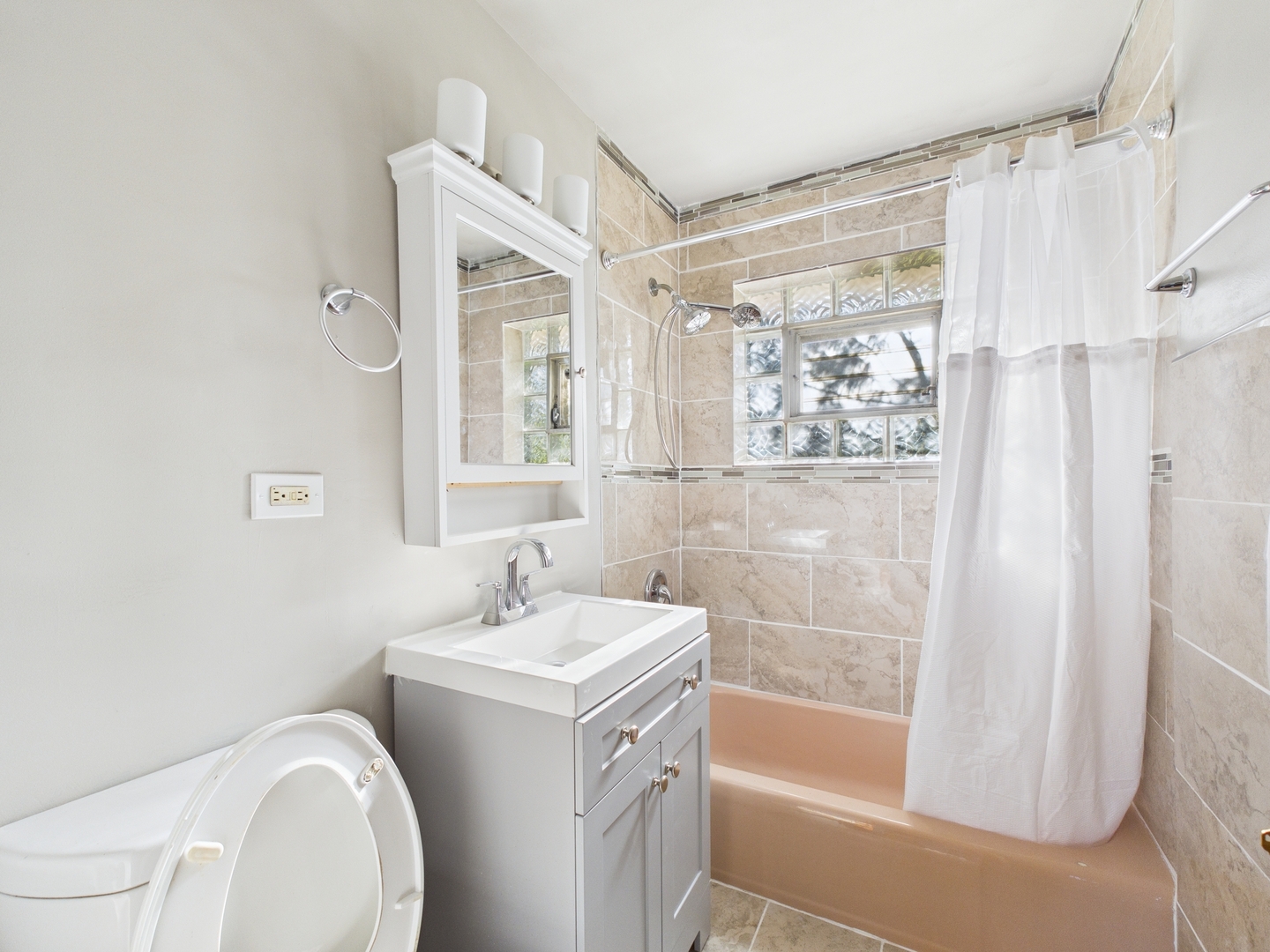 755 Dulles Road, Unit F Des Plaines, IL 60016 - Photo 11 of 12 a bathroom with a sink a toilet and shower