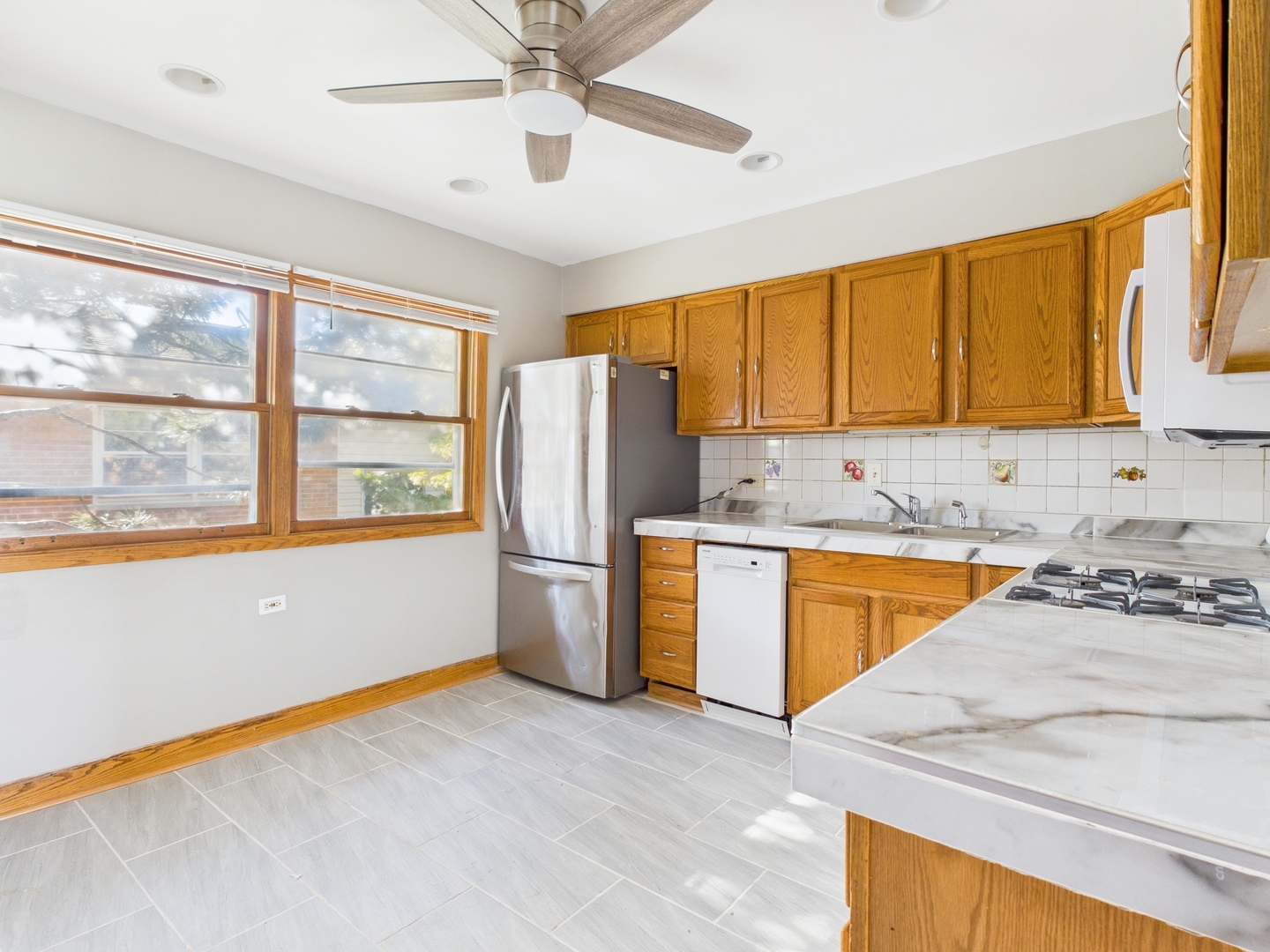 755 Dulles Road, Unit F Des Plaines, IL 60016 - Photo 5 of 12 a kitchen with stainless steel appliances granite countertop a stove a sink and a refrigerator