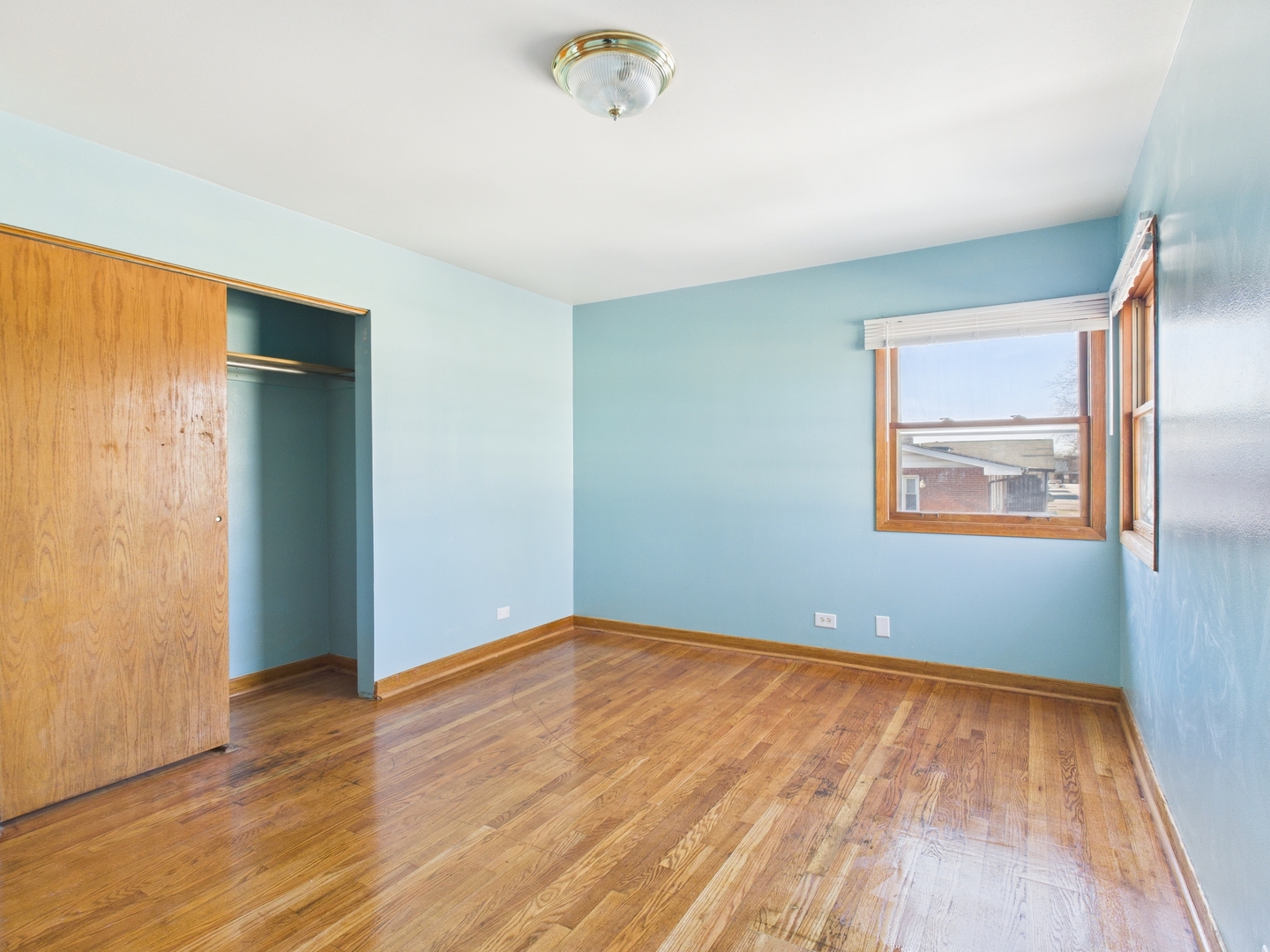 755 Dulles Road, Unit F Des Plaines, IL 60016 - Photo 7 of 12 an empty room with wooden floor and windows