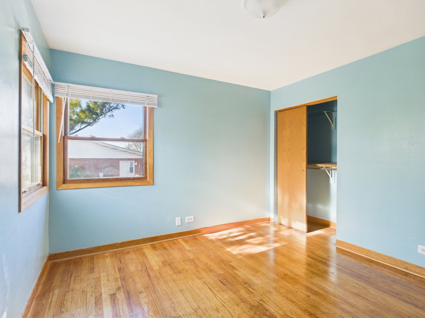 755 Dulles Road, Unit F Des Plaines, IL 60016 - Photo 9 of 12 an empty room with wooden floor and a window