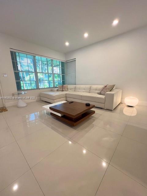1125 99th Street, Unit 12 Bay Harbor Islands, FL 33154 - Photo 2 of 62 a living room with furniture and a flat screen tv