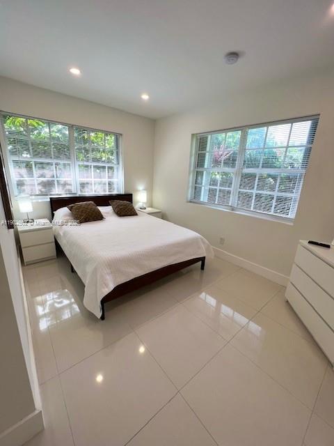 1125 99th Street, Unit 12 Bay Harbor Islands, FL 33154 - Photo 24 of 62 a bedroom with a bed and a large window