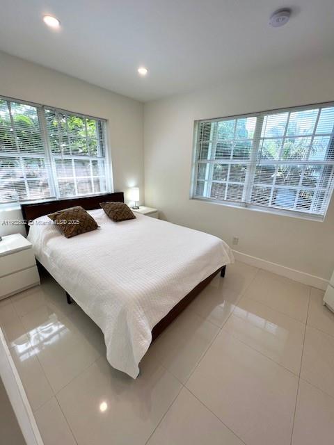 1125 99th Street, Unit 12 Bay Harbor Islands, FL 33154 - Photo 27 of 62 a bedroom with a bed and window