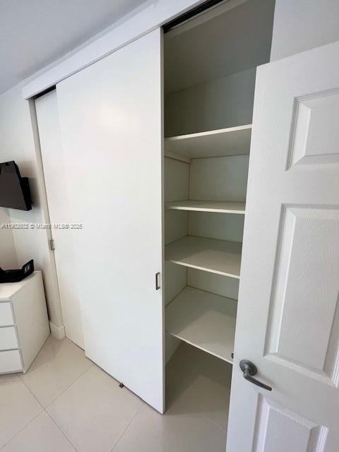 1125 99th Street, Unit 12 Bay Harbor Islands, FL 33154 - Photo 29 of 62 a view of walk in closet with empty racks