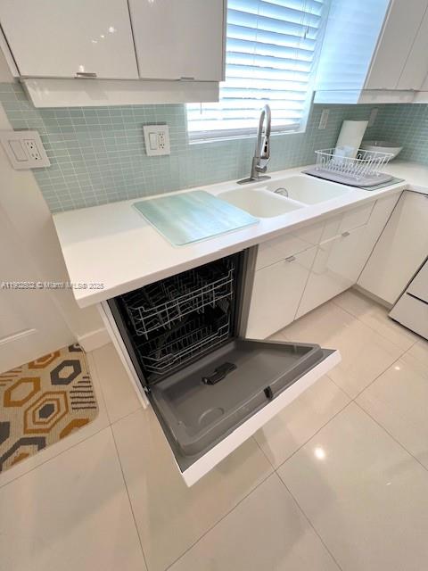 1125 99th Street, Unit 12 Bay Harbor Islands, FL 33154 - Photo 30 of 62 a kitchen with a sink a stove and cabinets