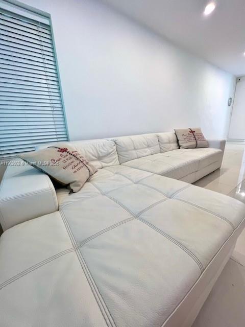 1125 99th Street, Unit 12 Bay Harbor Islands, FL 33154 - Photo 4 of 62 a bedroom with a bed and a couch