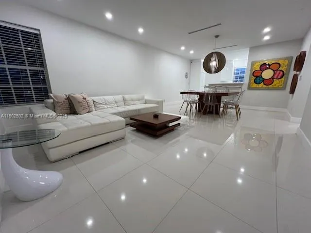 a bedroom with a bed a table and a large mirror