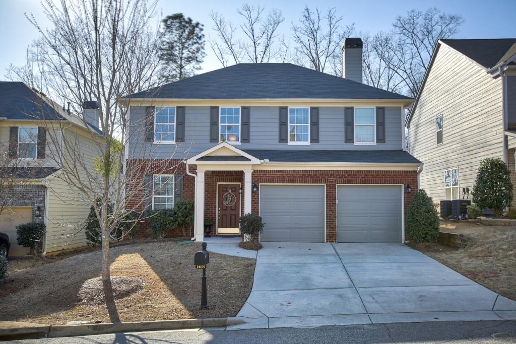 3655 Silver Springs Road Cumming, GA 30041 - Photo 1 of 1 a front view of a house with garden