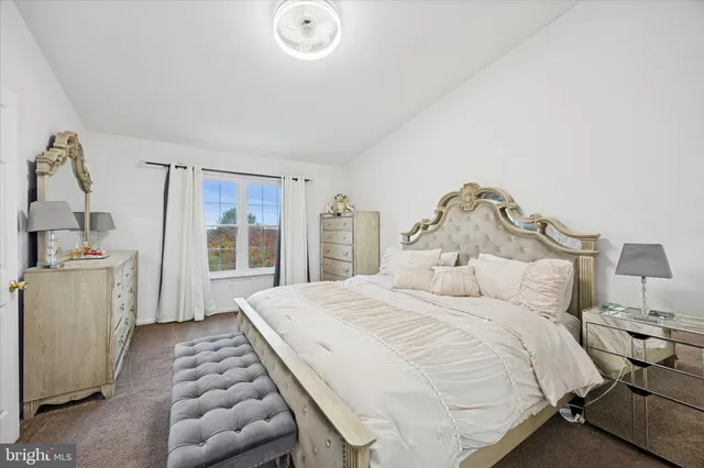 a spacious bedroom with a bed and a window