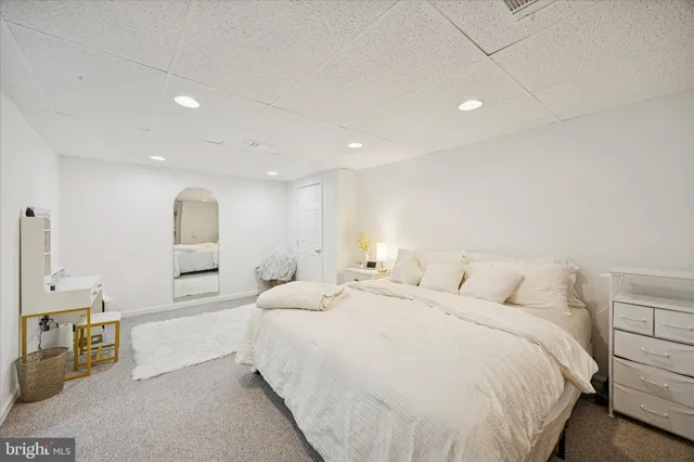 a large bedroom with a bed and a large window