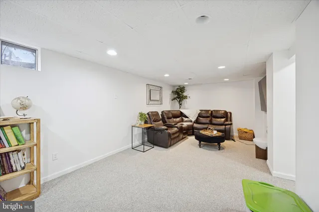 a living room with furniture and a book shelf