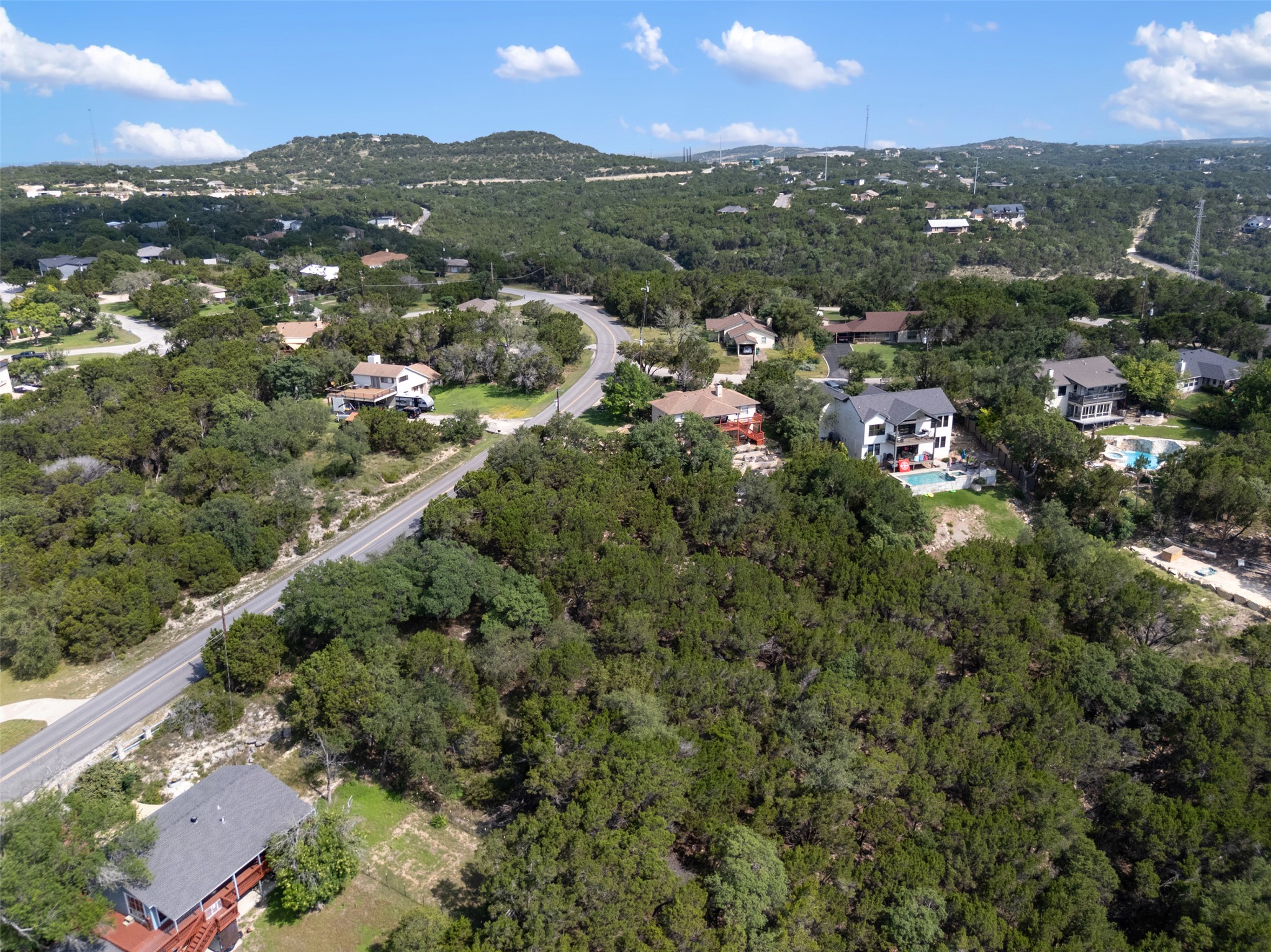 21105 Ridgeview Road Lago Vista, TX 78645 - Photo 9 of 34 Perched on a verdant hillside, this property offers panoramic views of the surrounding natural landscape.