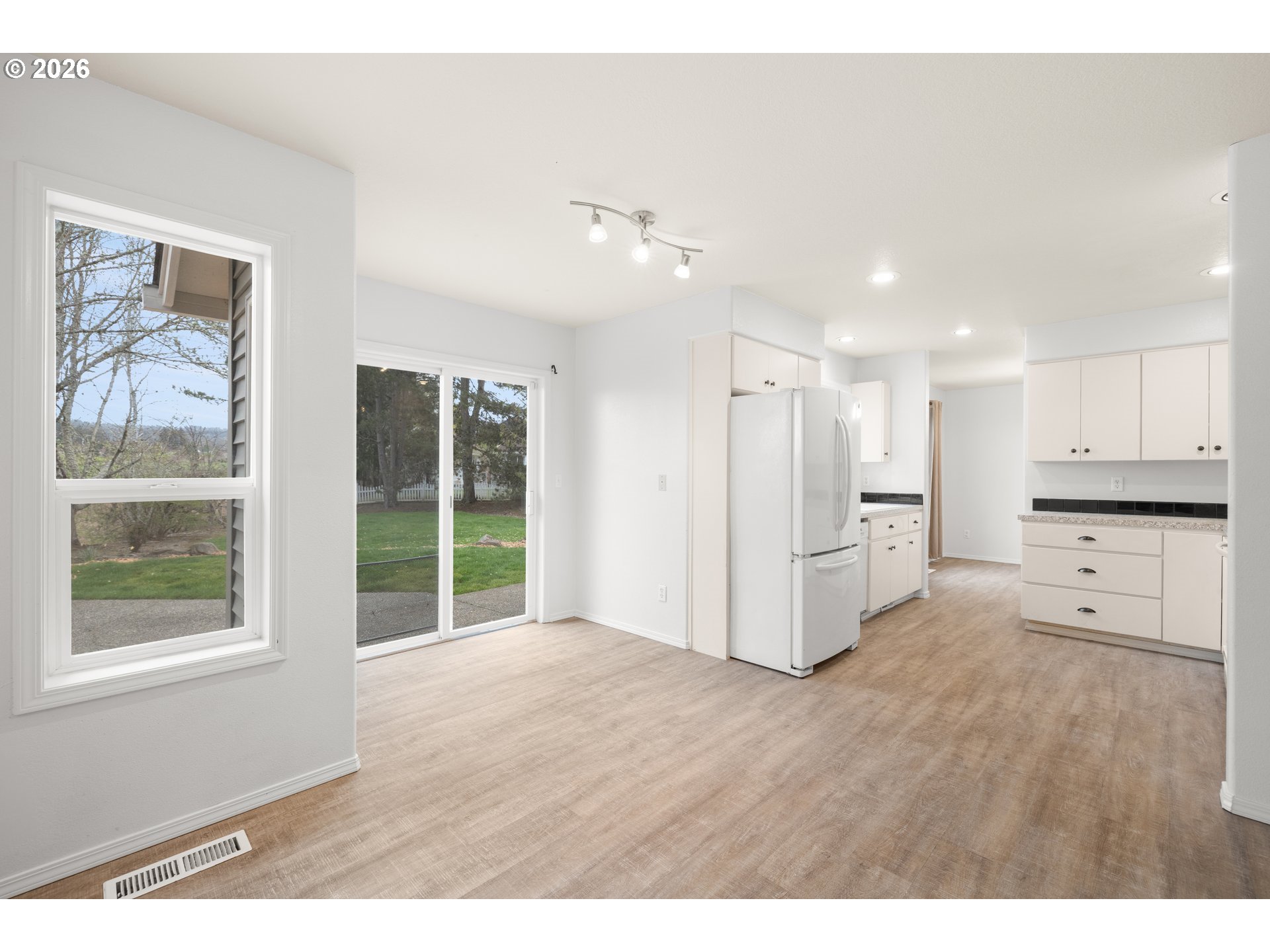 5572 Northwest 165th Place Portland, OR 97229 - Photo 16 of 48 a view of a kitchen with furniture and wooden floor