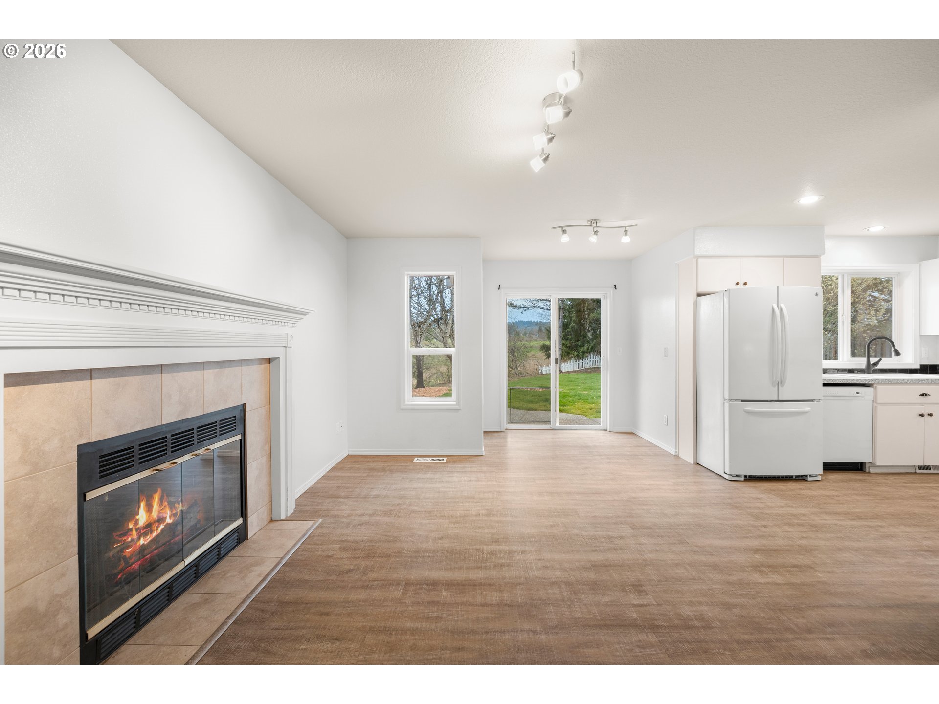 5572 Northwest 165th Place Portland, OR 97229 - Photo 17 of 48 a view of an empty room with kitchen and fireplace