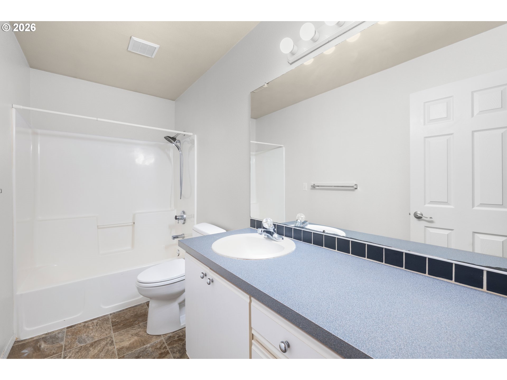 5572 Northwest 165th Place Portland, OR 97229 - Photo 31 of 48 a bathroom with a sink a toilet a mirror and shower