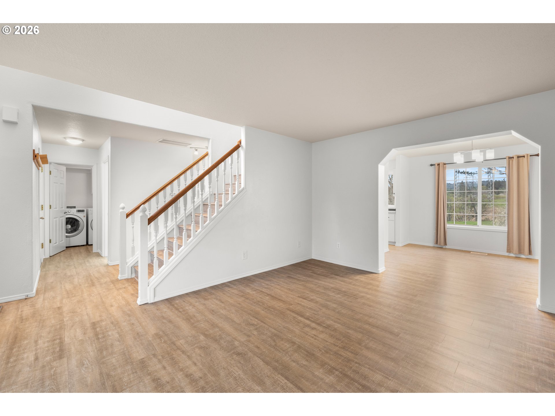 5572 Northwest 165th Place Portland, OR 97229 - Photo 7 of 48 a view of an empty room with wooden floor and a living room