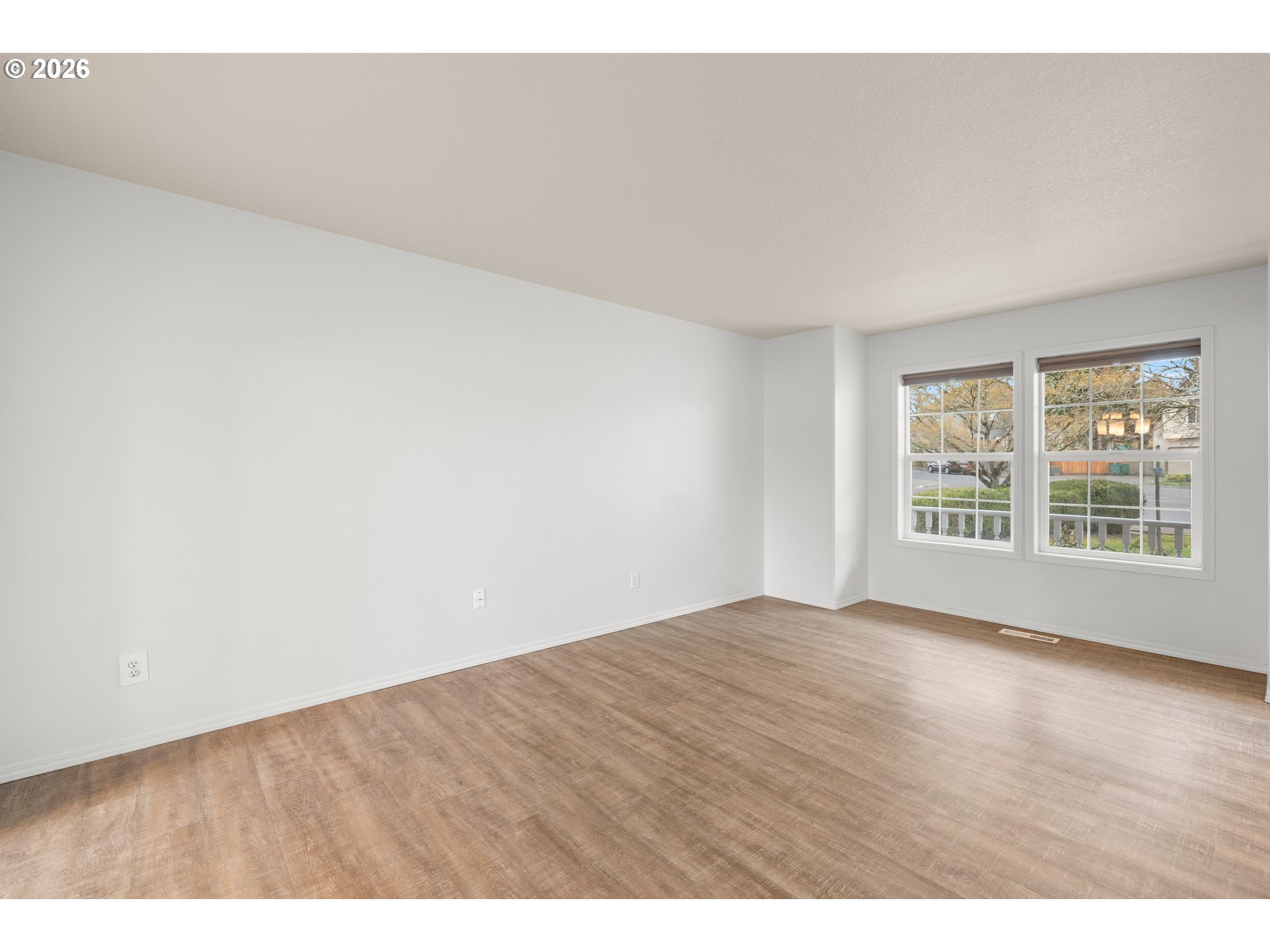 5572 Northwest 165th Place Portland, OR 97229 - Photo 8 of 48 a view of an empty room with wooden floor and a window