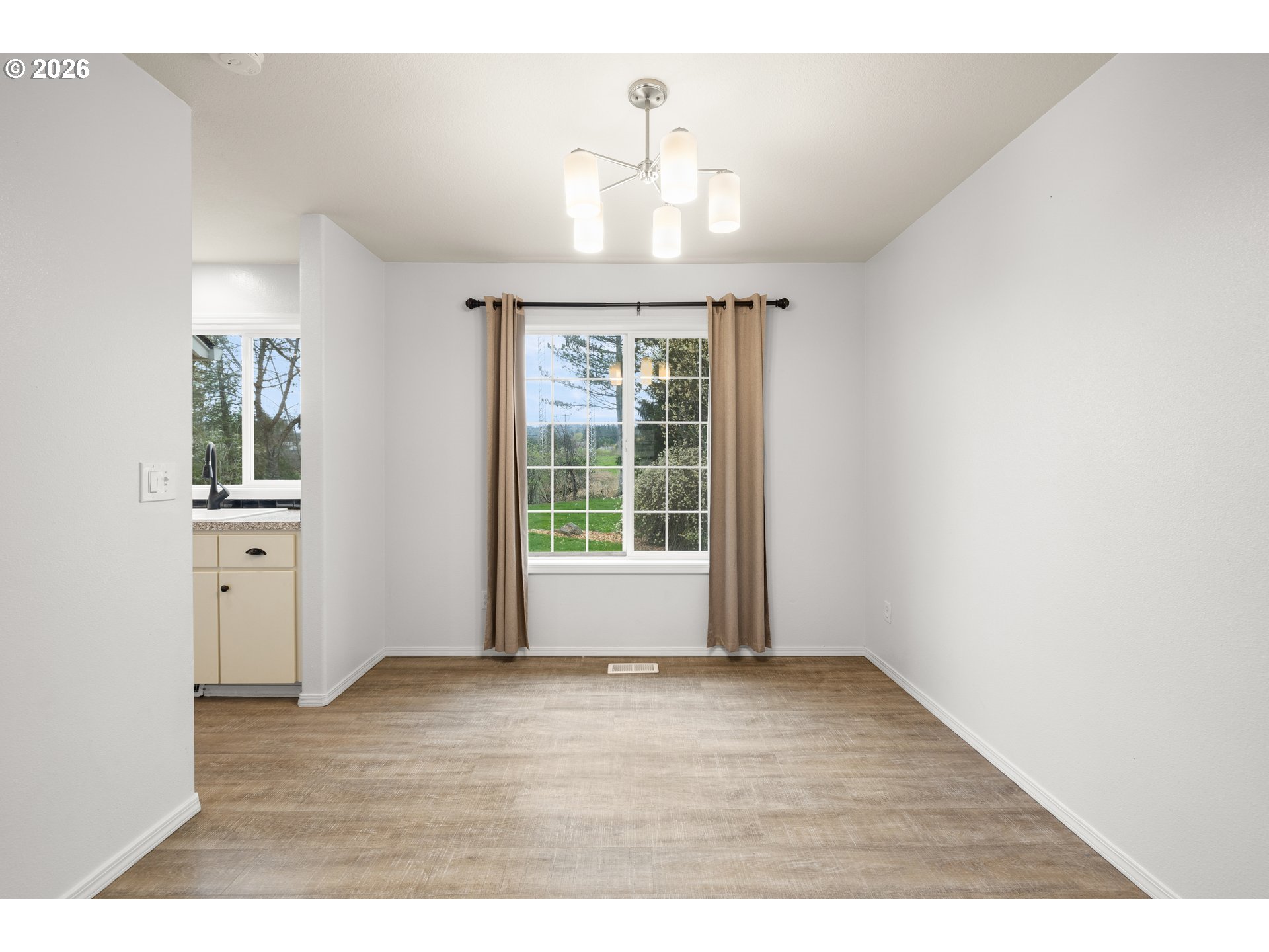 5572 Northwest 165th Place Portland, OR 97229 - Photo 9 of 48 a view of an empty room with wooden floor and a window