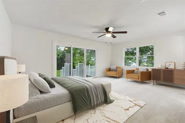 a bedroom with furniture and a large window