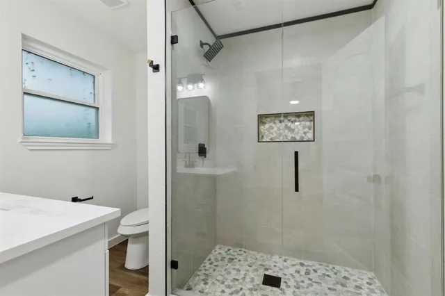 a bathroom with a shower and a sink