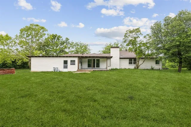 a view of an house with backyard space and garden