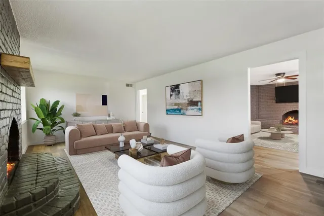 a living room with furniture and a potted plant
