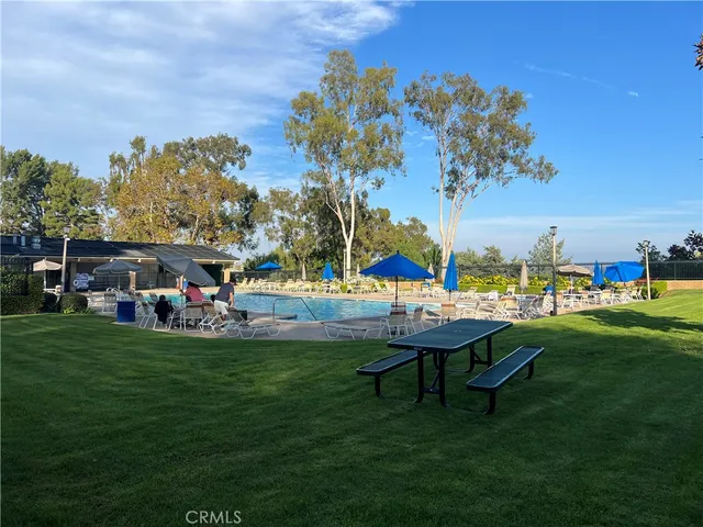 a view of a table and chairs in the grass