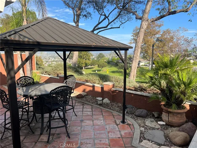 a view of a patio with table and chairs and potted plants