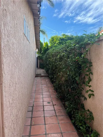 a view of a pathway both side of house