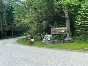 Lot 21 Village Run Road Boswell, PA 15531 - Photo 3 of 4 a sign that is sitting in the grass next to a road