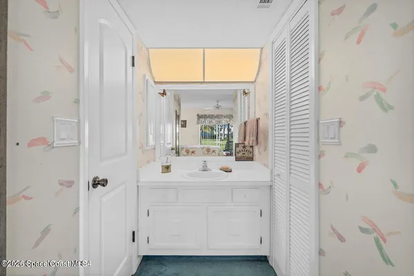 a bathroom with a sink mirror and a shower
