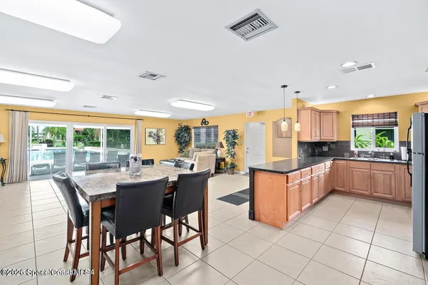 a large kitchen with a table and chairs