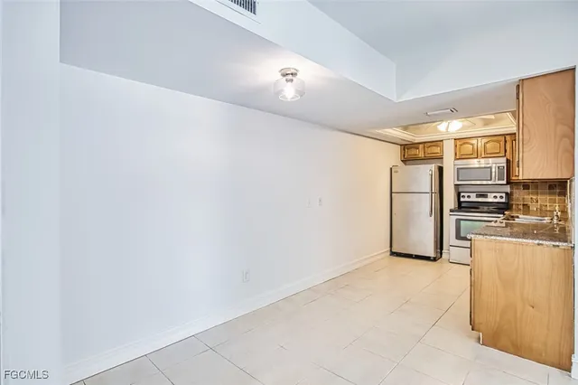 a kitchen with stainless steel appliances a refrigerator and cabinets