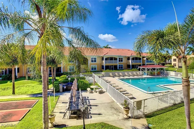 a view of a swimming pool with lounge chairs