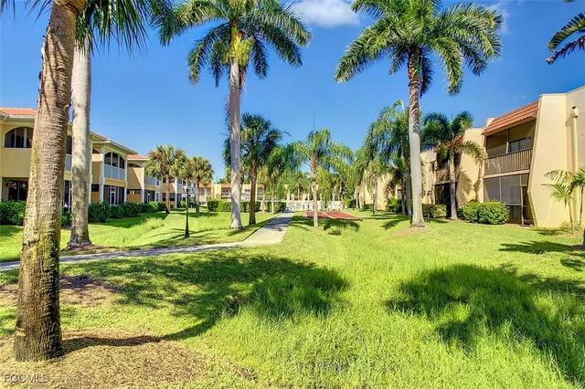 a view of a house with swimming pool and a yard