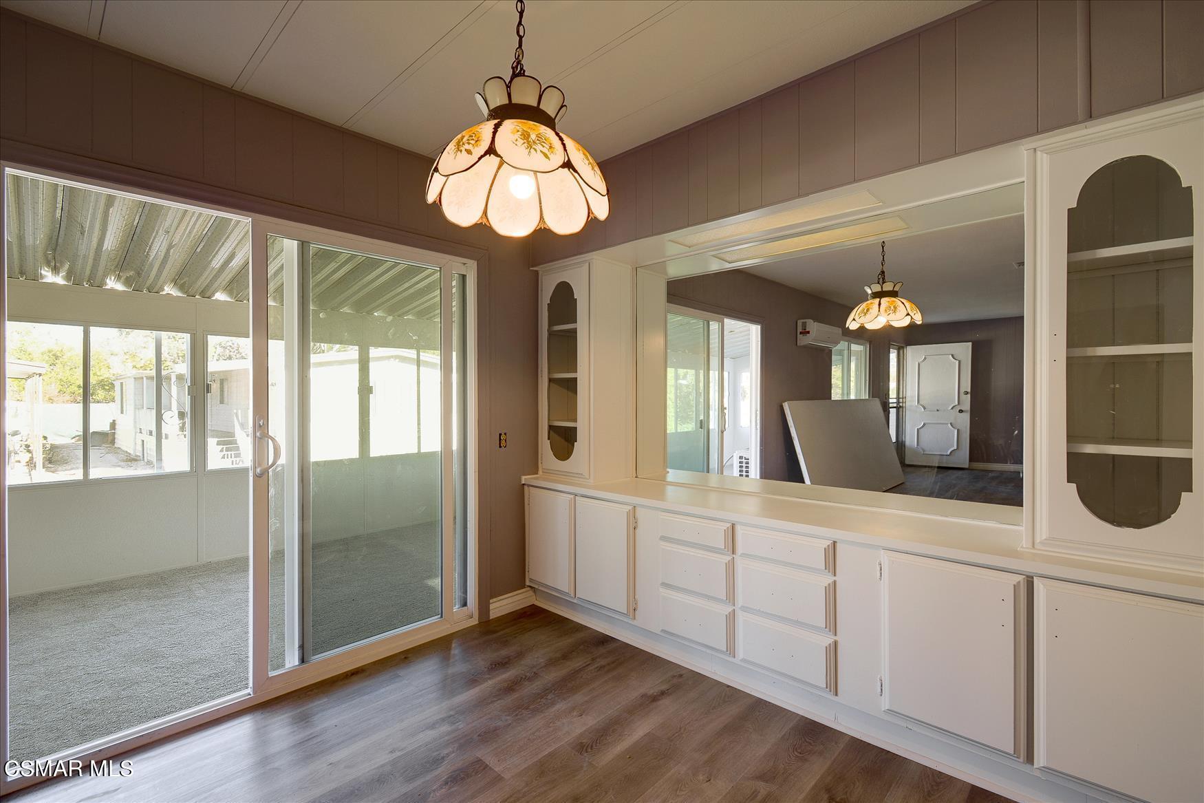 6480 Katherine Road, Unit 21 Simi Valley, CA 93063 - Photo 16 of 42 a view of a hallway with wooden floor and chandelier