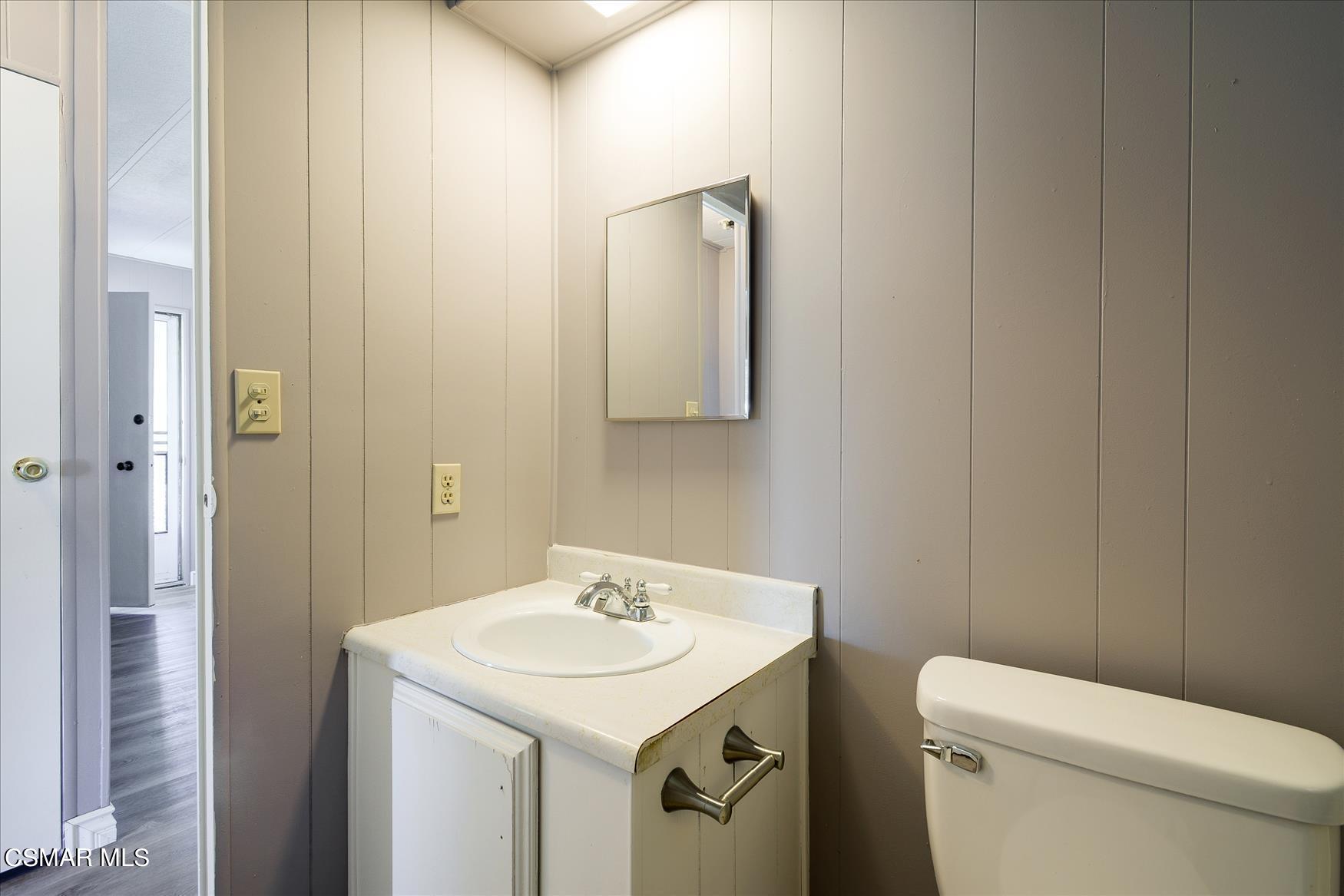 6480 Katherine Road, Unit 21 Simi Valley, CA 93063 - Photo 20 of 42 a bathroom with a sink a toilet and mirror