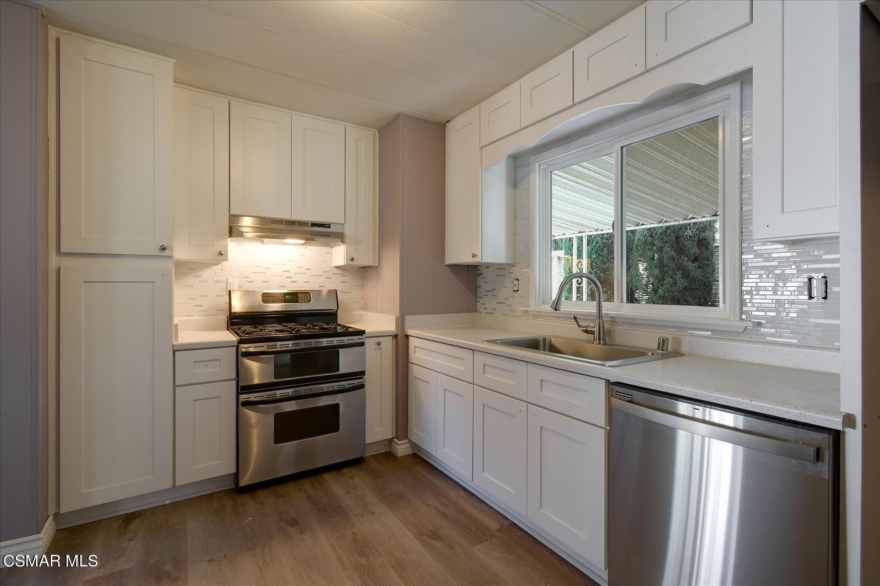 6480 Katherine Road, Unit 21 Simi Valley, CA 93063 - Photo 21 of 42 a kitchen with a sink appliances and cabinets
