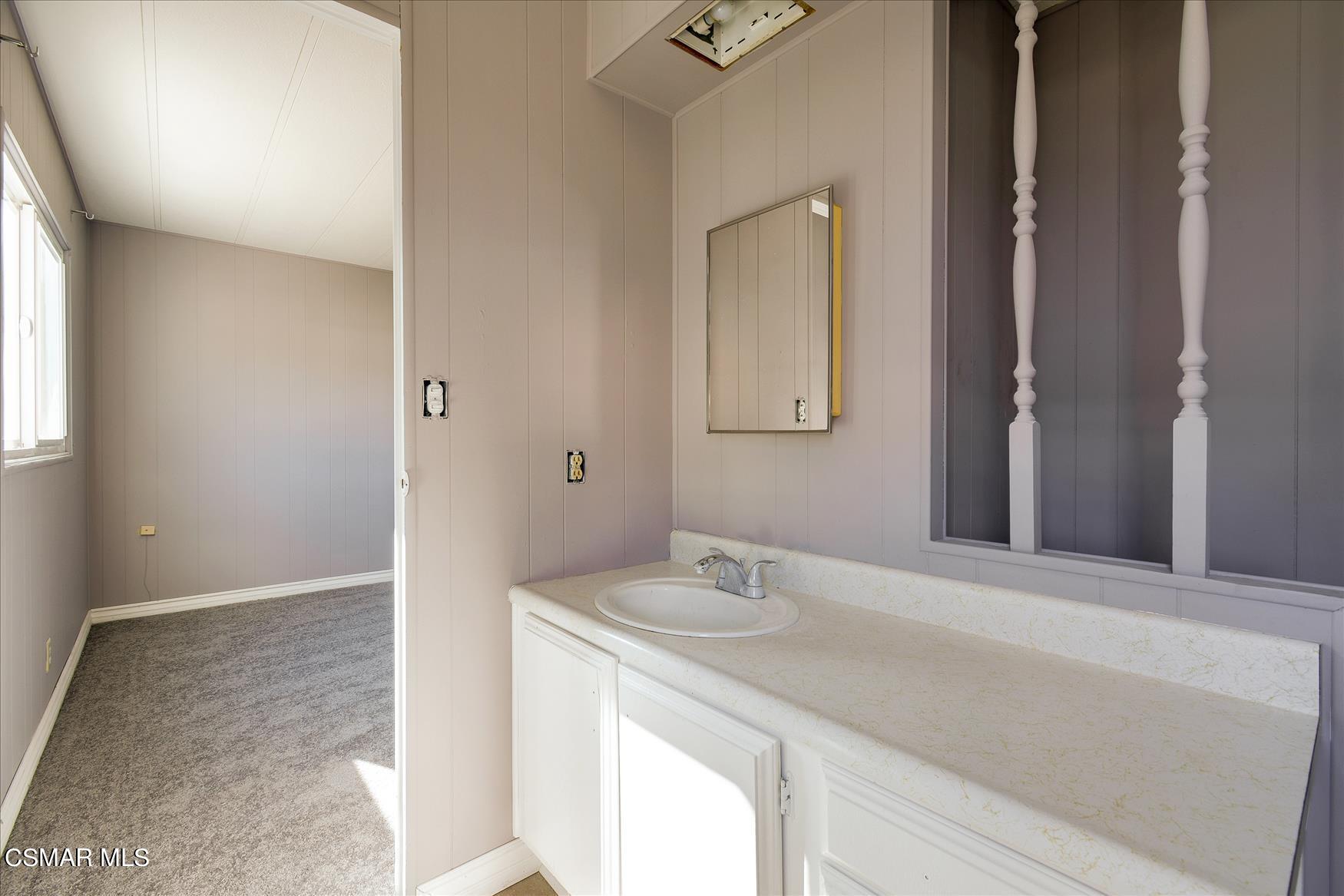 6480 Katherine Road, Unit 21 Simi Valley, CA 93063 - Photo 23 of 42 a bathroom with a sink and a mirror
