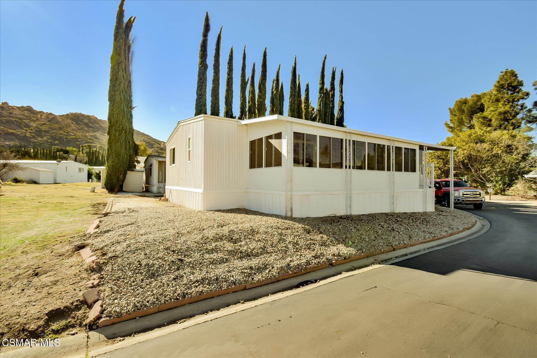 6480 Katherine Road, Unit 21 Simi Valley, CA 93063 - Photo 40 of 42 a front view of a house with a yard
