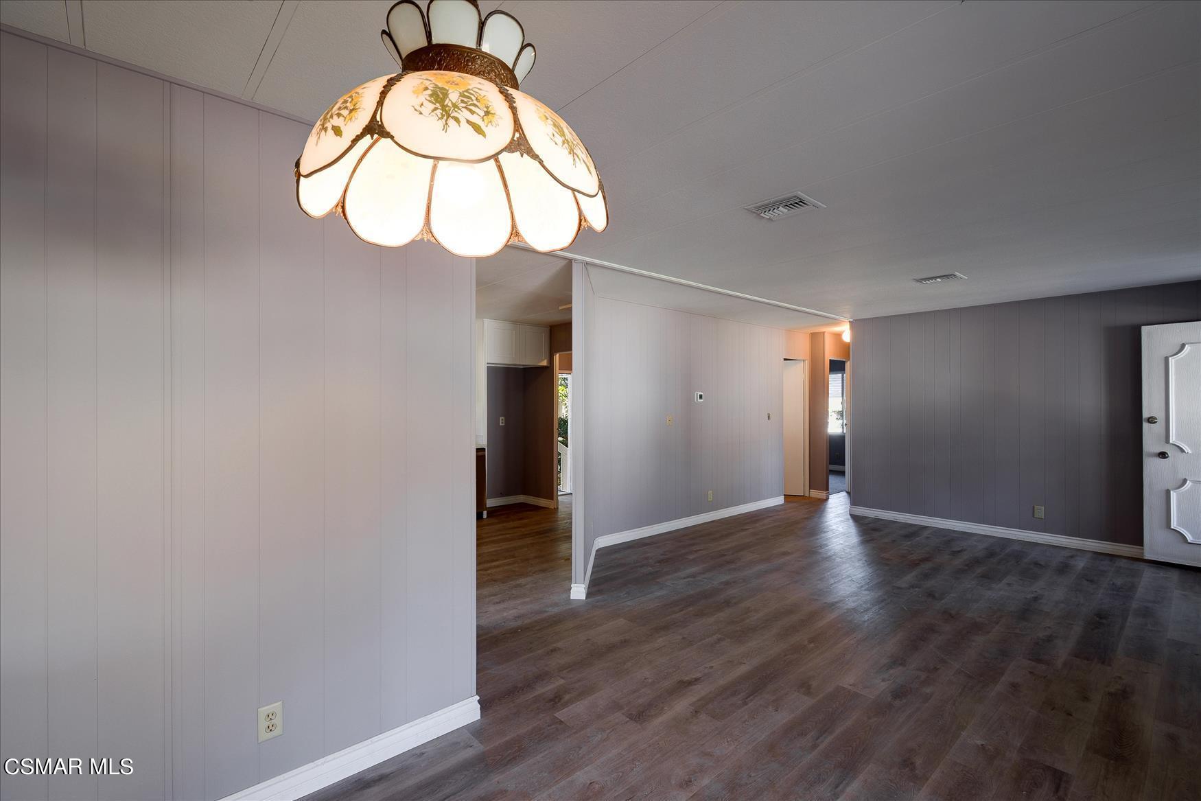 6480 Katherine Road, Unit 21 Simi Valley, CA 93063 - Photo 6 of 42 a view of an empty room with wooden floor and a window