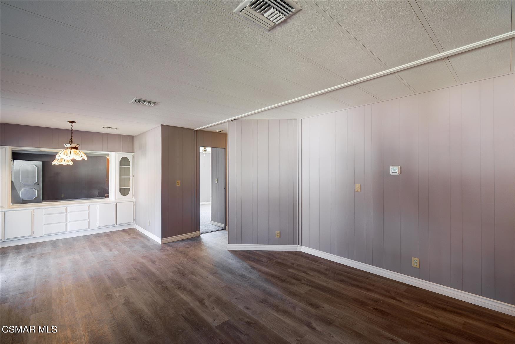 6480 Katherine Road, Unit 21 Simi Valley, CA 93063 - Photo 7 of 42 a view of an empty room with wooden floor and a window