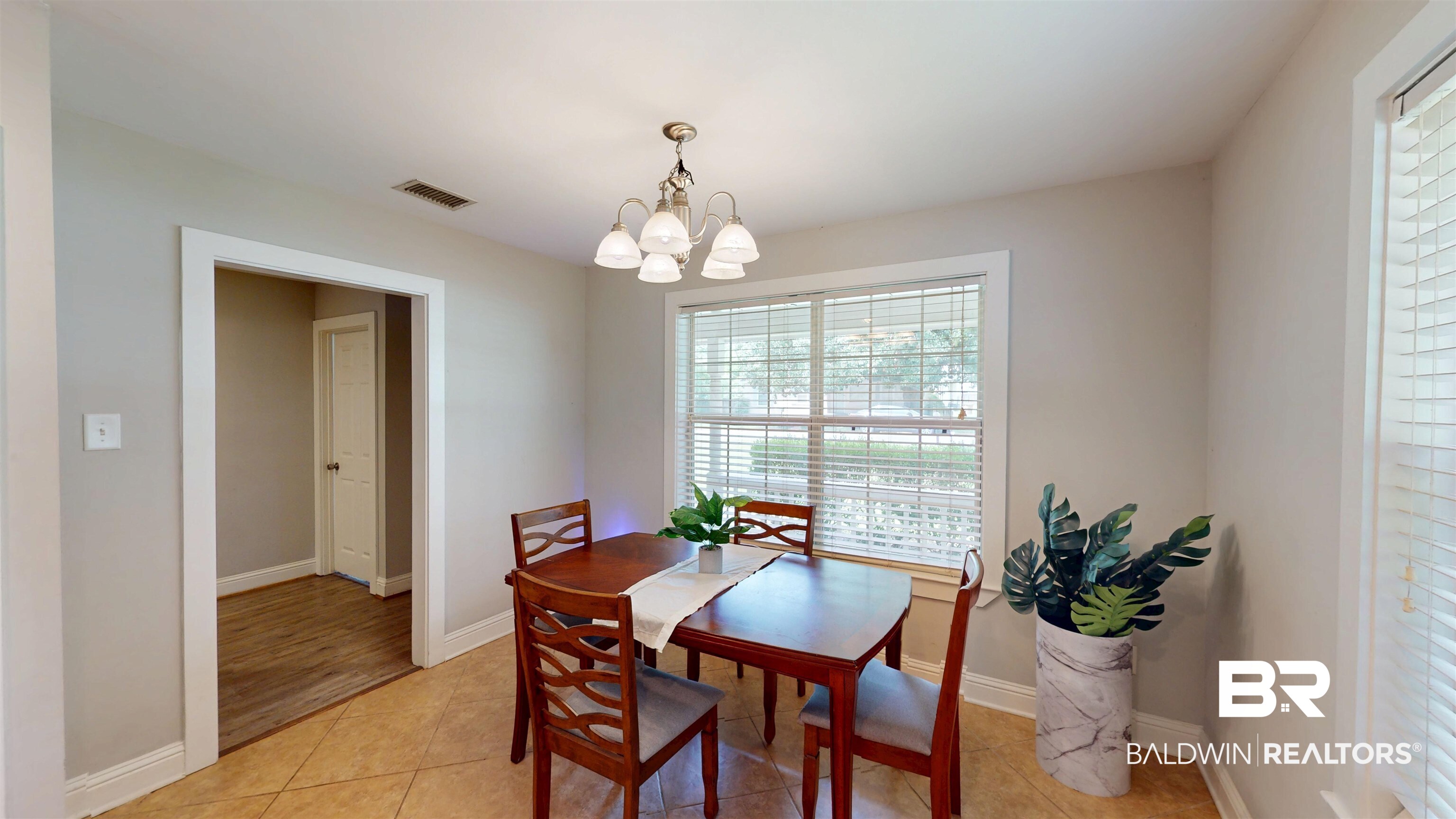 51 Bishop Lane South Mobile, AL 36608 - Photo 7 of 19 Dining area featuring light tile patterned flooring, healthy amount of natural light, and a chandelier