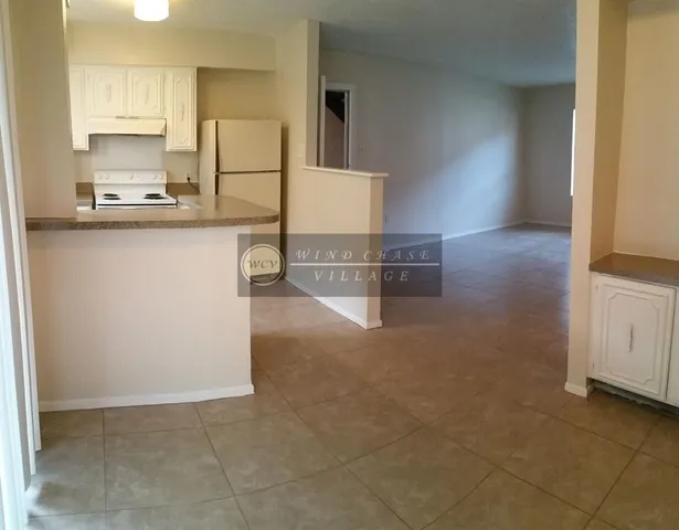 a kitchen with kitchen island cabinets and refrigerator