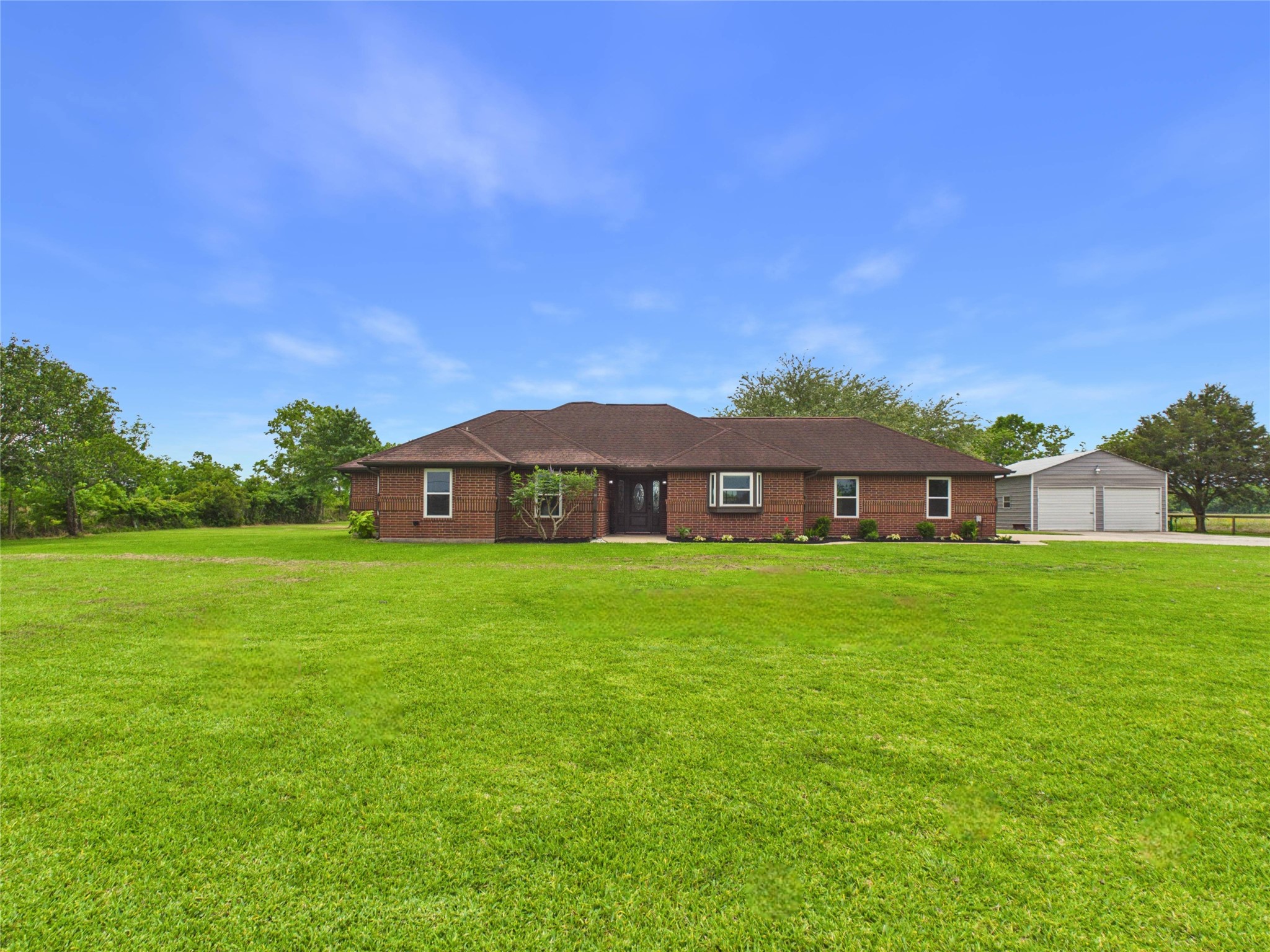 4610 Mustang Road Alvin, TX 77511 - Photo 2 of 50 Home sits on 1.5 acres, has two car attached garage and detached metal workshop/2 bay, a long list of updates and a gated driveway off a private road. No HOA! Long gated driveway, plenty of room to park boat, RV or both