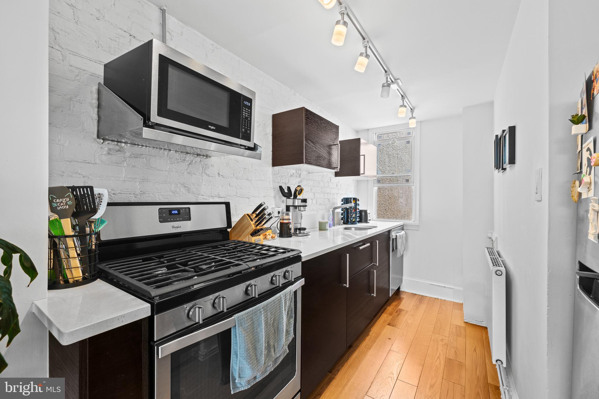 726 South 19th Street Philadelphia, PA 19146 - Photo 7 of 12 a kitchen with stainless steel appliances granite countertop a stove and a sink