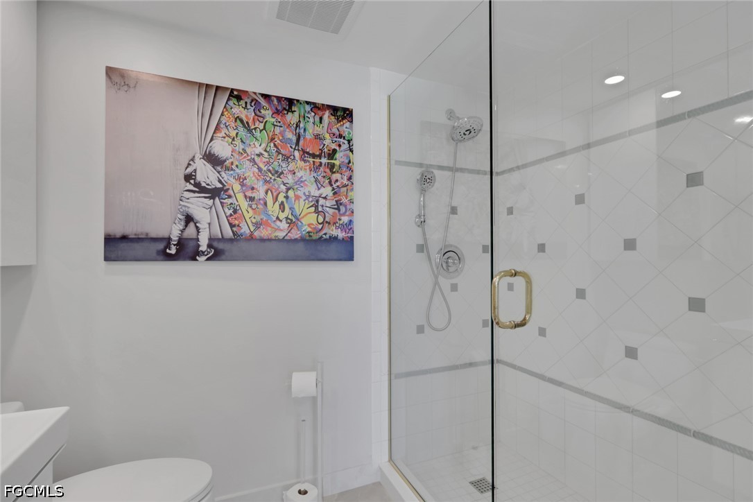 9 High Point Circle North, Unit 101 Naples, FL 34103 - Photo 24 of 49 a bathroom with a shower and toilet