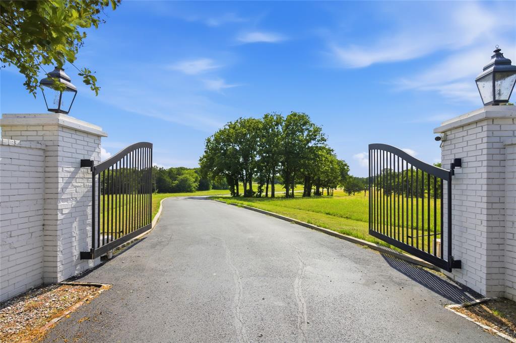 1073 Gordonville Road Gordonville, TX 76245 - Photo 2 of 39 Welcome! A brick entry with a remote control gate leads you on a paved road with curbs into this property.